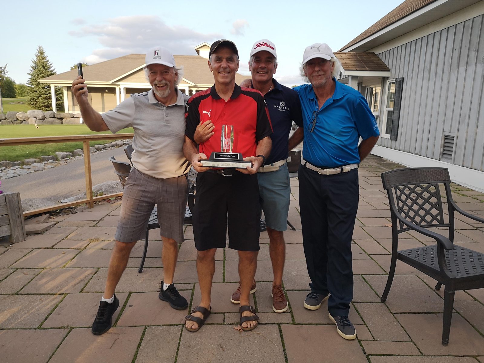 The Friendly Finn trophy, held by the 2020 winning foursome